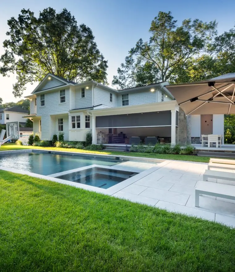 Luxury custom home with backyard pool and motorized patio screen outdoor living area
